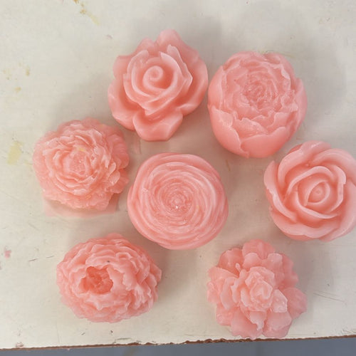 Blush pink handcrafted soap roses, set of seven, on a cream surface