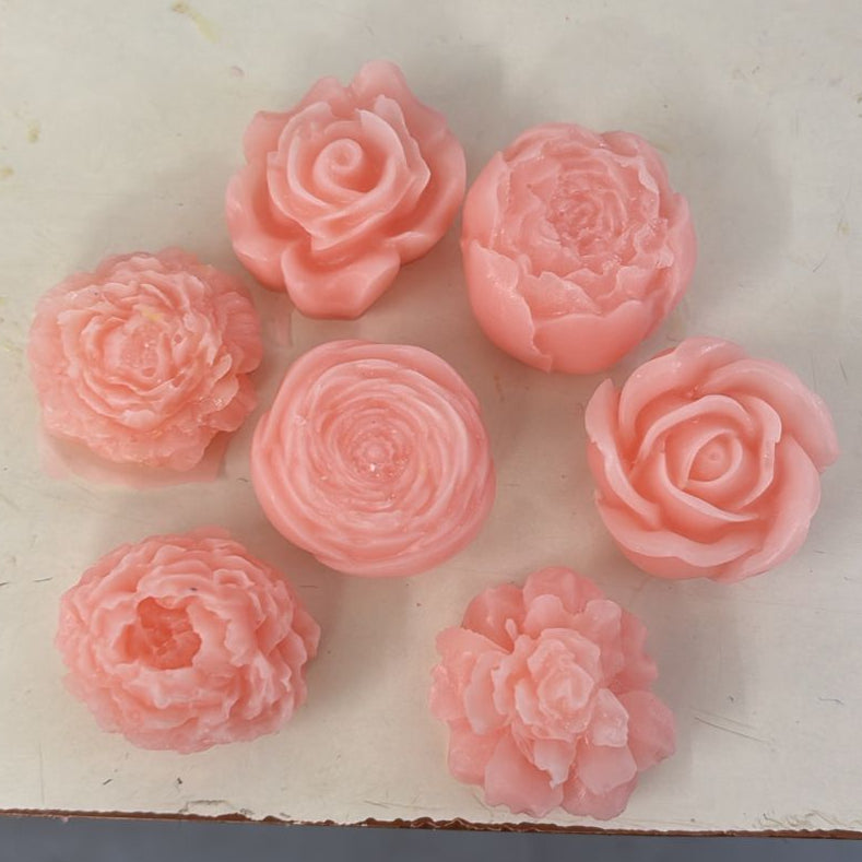 Blush pink handcrafted soap roses arranged on a light background